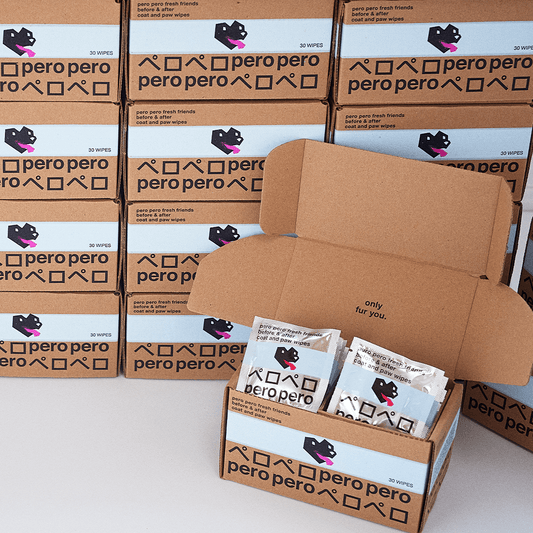 A box of PeroPero wipes is placed in front of a backdrop of numerous identical boxes, each containing 30 wipes. This image emphasizes the product's branding and the consistency of the packaging.